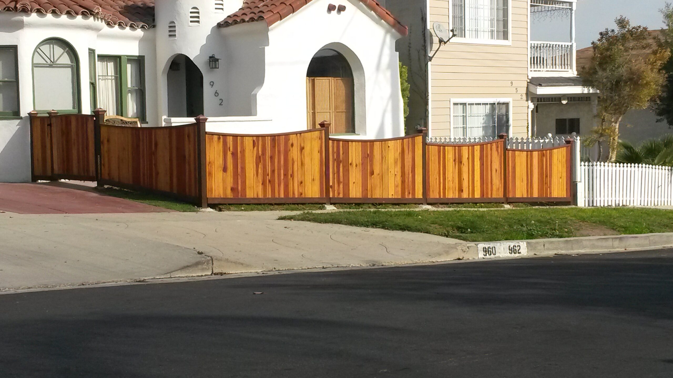 Custom Scallop Top Front Yard Wood Fence on a Slope, San Pedro 90731, designed, built & stained by WoodFenceExpert.com