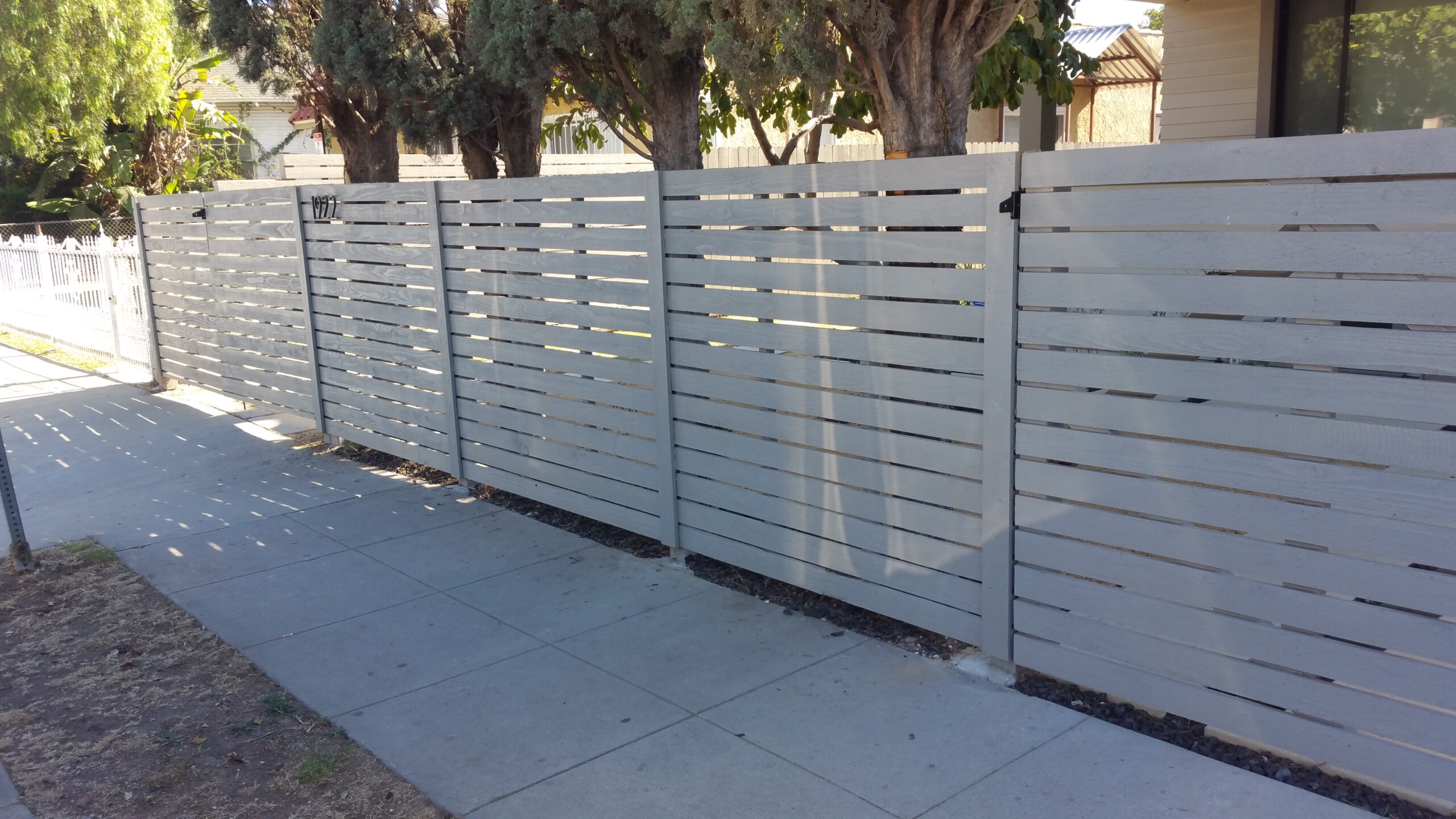 Custom, Modern Horizontal Wood Fence + Matching Pedestrian and Double-Swinger Driveway Gates in Los Angeles 90018, designed, built & painted by WoodFenceExpert.com